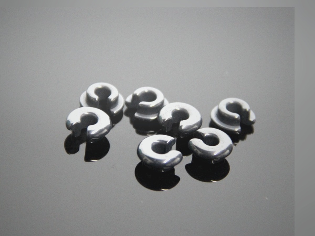 Black specialty ceramic parts on a graphite surface